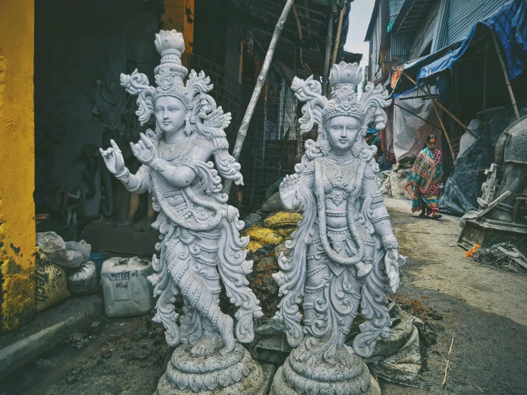 statues of women on a pedestal on a street