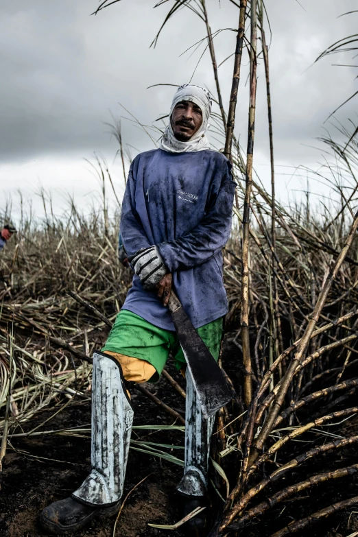 a man with an injured arm holding a giant knife