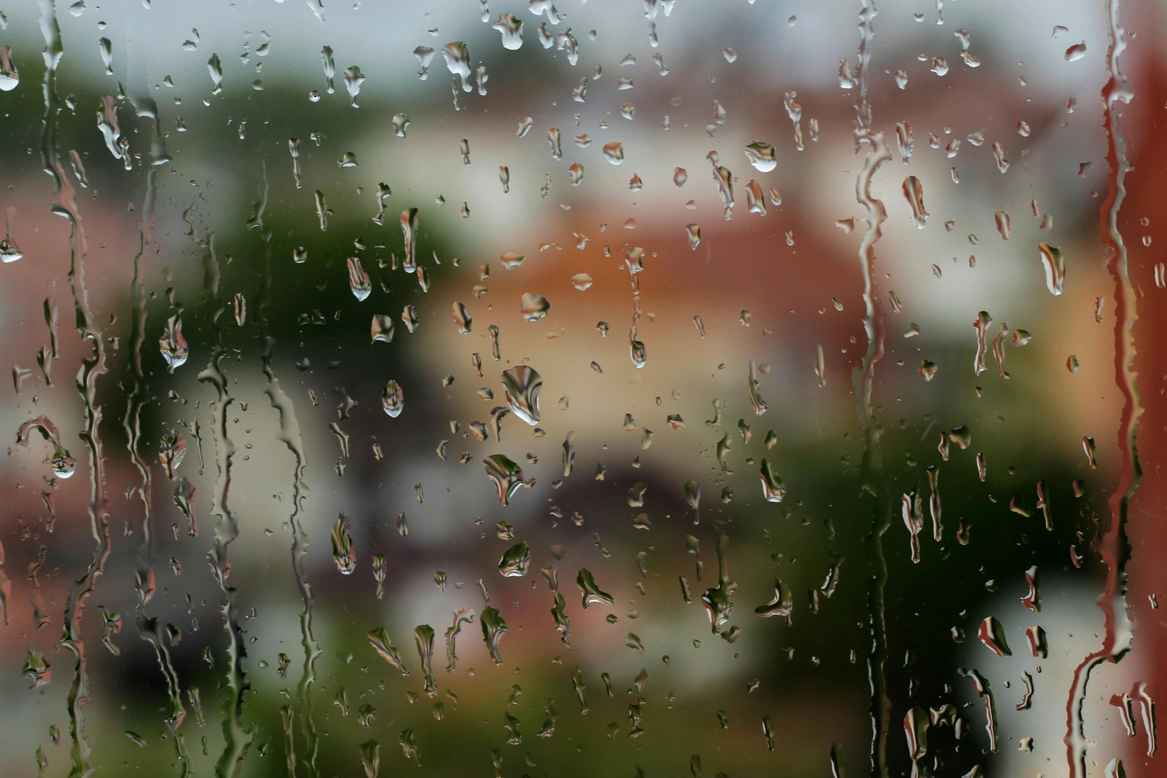 the outside of a window, covered in rain