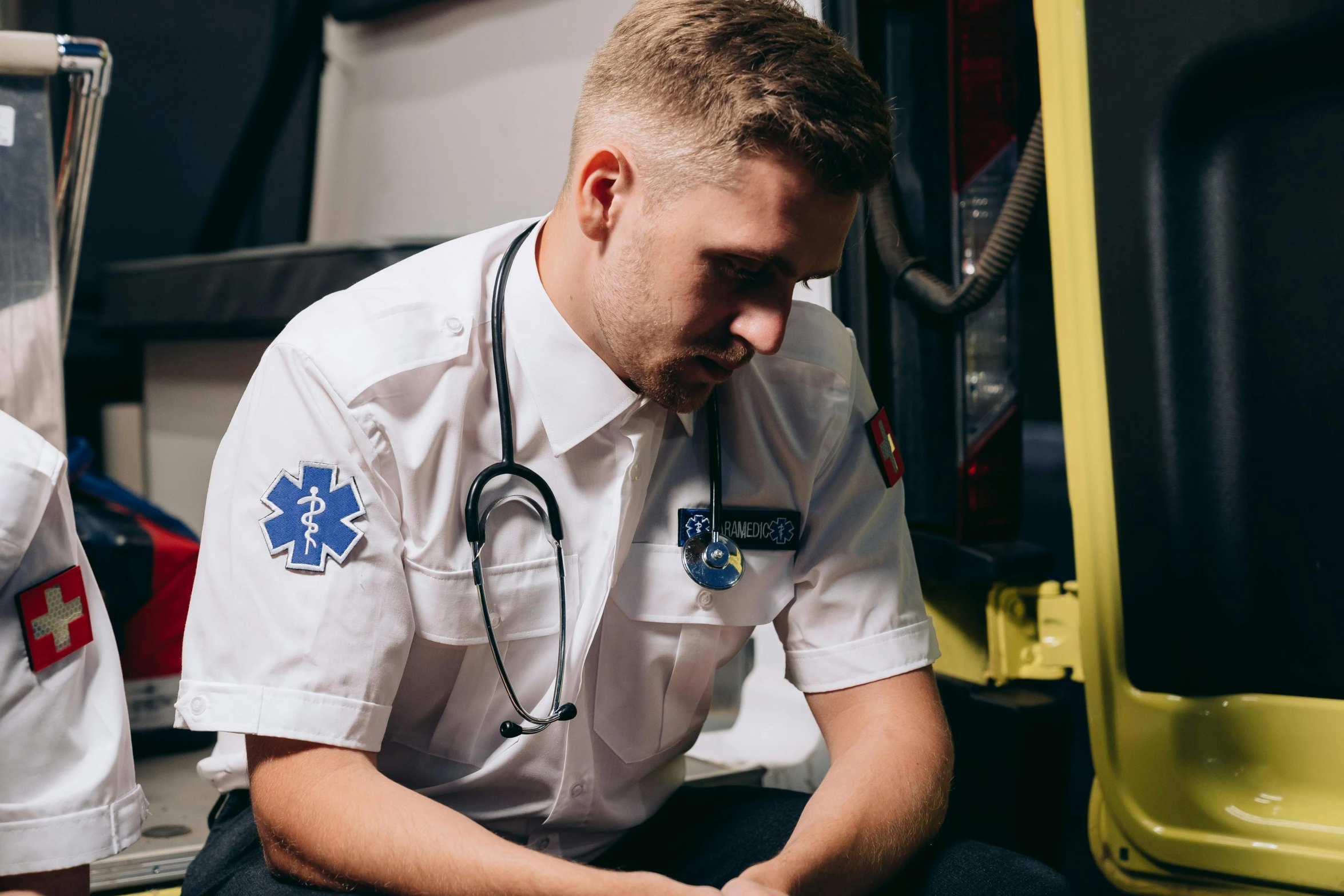 a man sitting down with a stethoscope on his hand