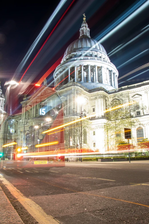 lights streak up from behind a large church