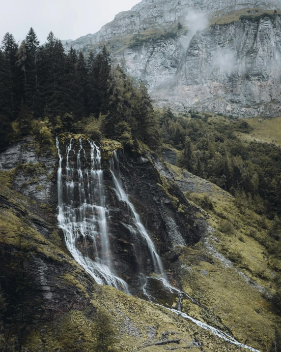 there is a large waterfall that is coming down the mountain