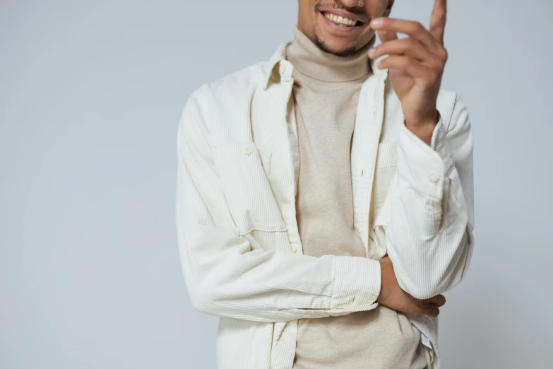 the man poses for a portrait and points