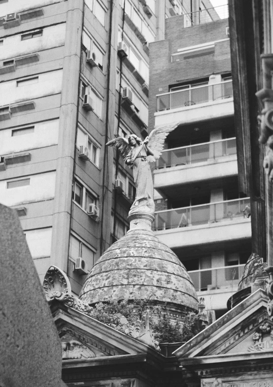 a black and white pograph of an angel statue