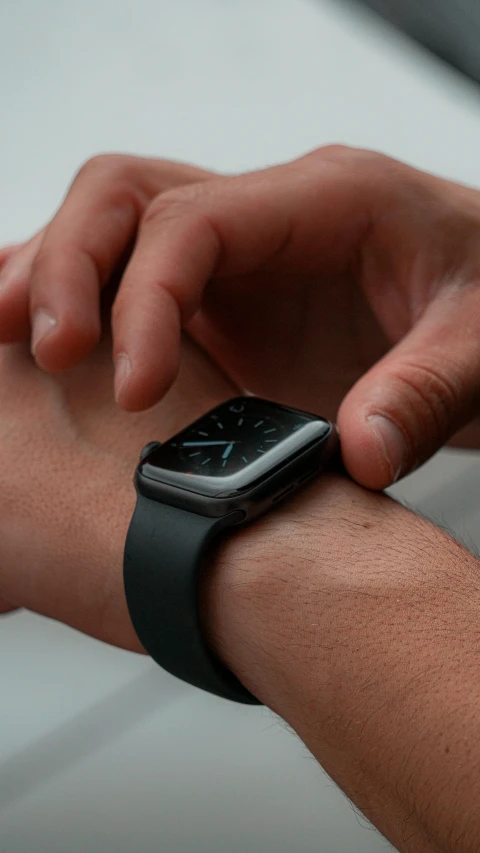 a person in a watch showing his wrist