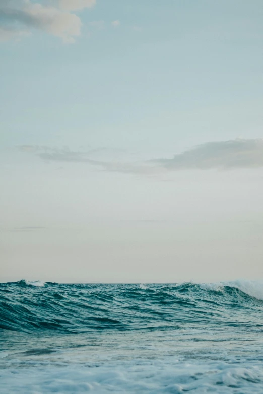 a man riding a surfboard on top of a wave