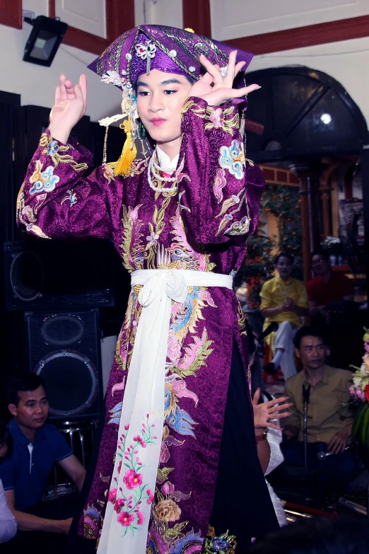 a woman is wearing an oriental - style costume for a performance