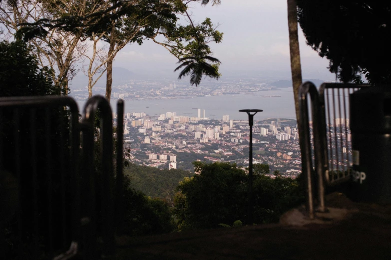 a view from top of a hill with mountains and trees in the foreground