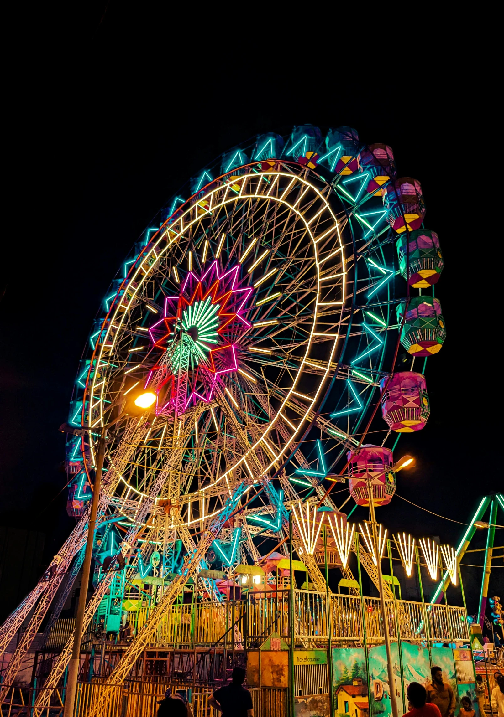 a ferris wheel is illuminated brightly for the night