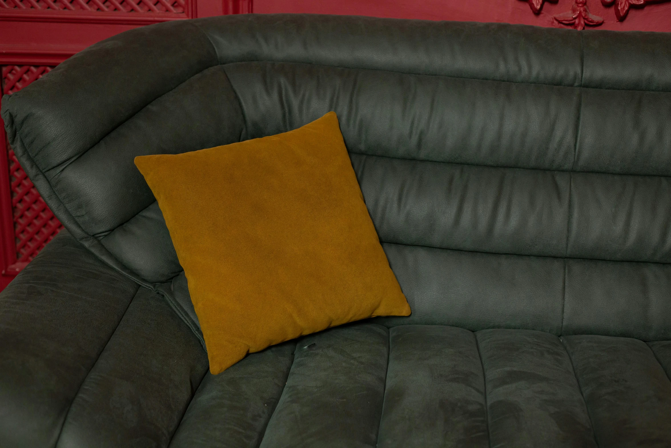 an orange and grey couch with a pillow on it