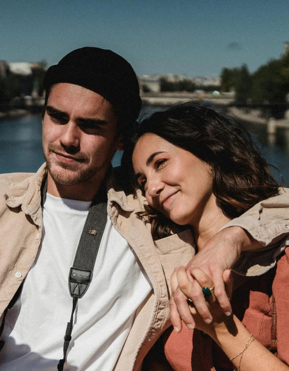 a woman poses with her arm around a man