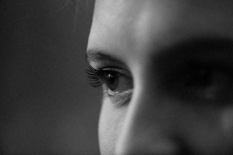 black and white pograph of a woman's eye looking down