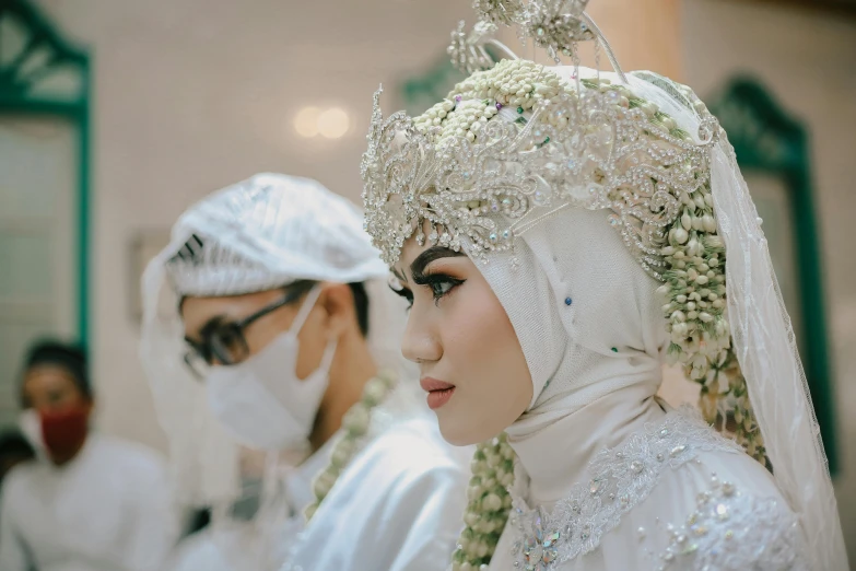 two women in headgear and veils stand together