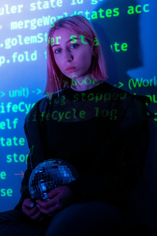 a woman in black holding a mirror ball