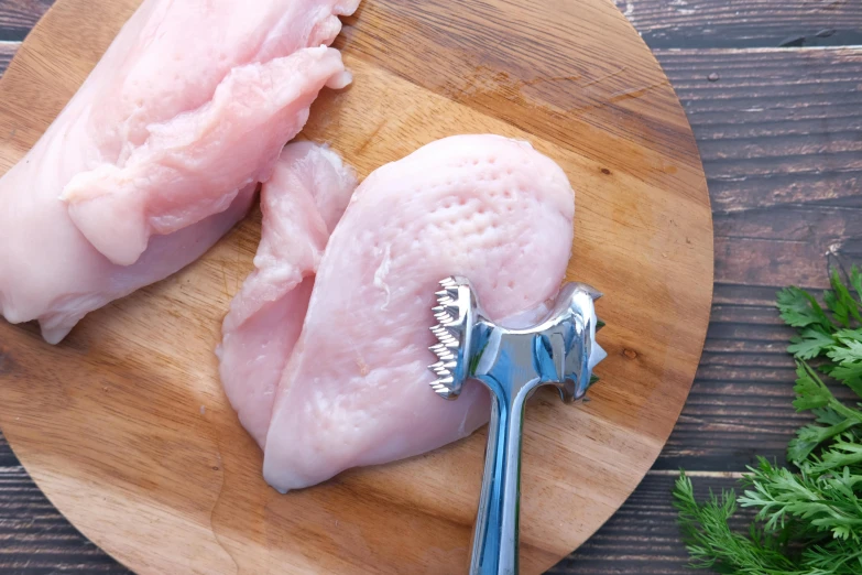 two raw meats are sitting on a wooden surface