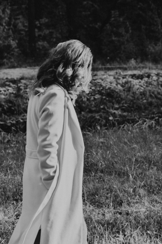 black and white po of a young woman standing in a field
