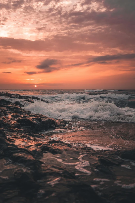 sunset over a sea line with waves hitting