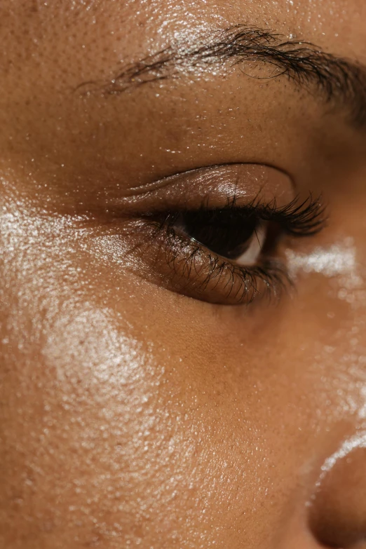 a female eyes with a light shining through the upper part