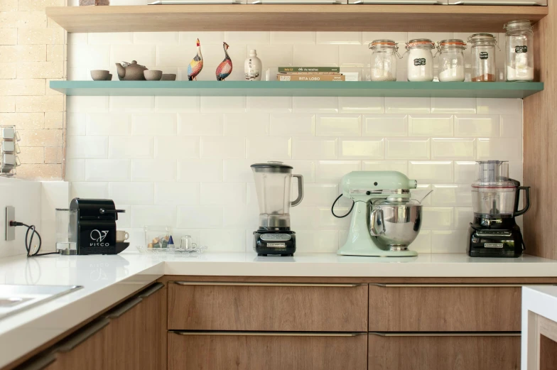 a shelf above a kitchen sink filled with appliances