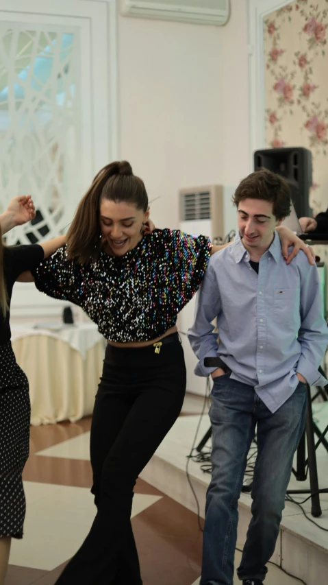 two people dance in a large room