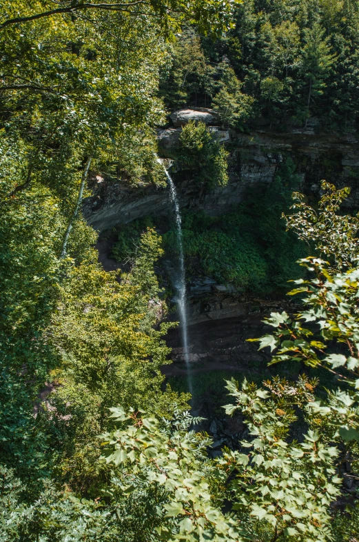 a small waterfall on top of a large waterfall