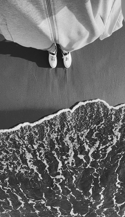 a couple standing next to each other on a beach