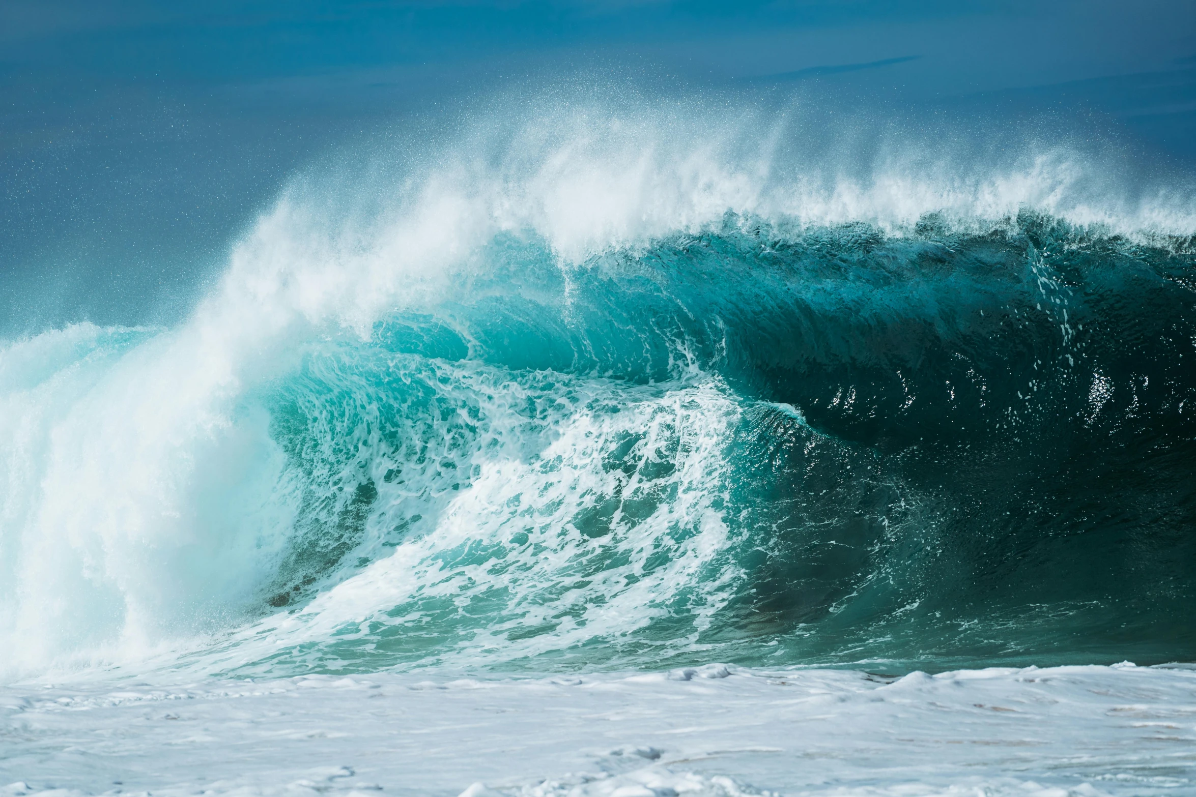 a large wave in the ocean crashes over