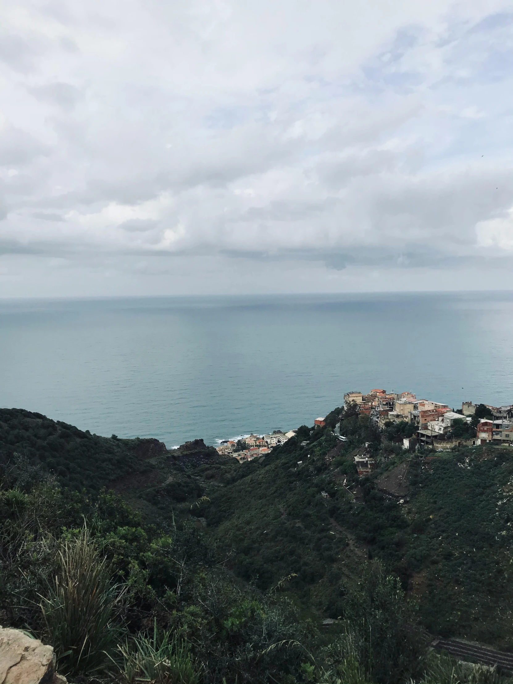 a town perched on a hill overlooking a body of water