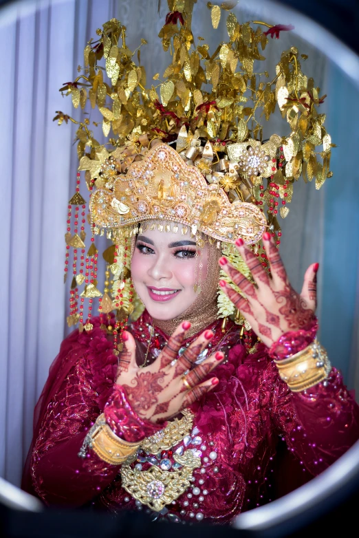 a girl dressed up in elaborately designed costume with lots of gold coins