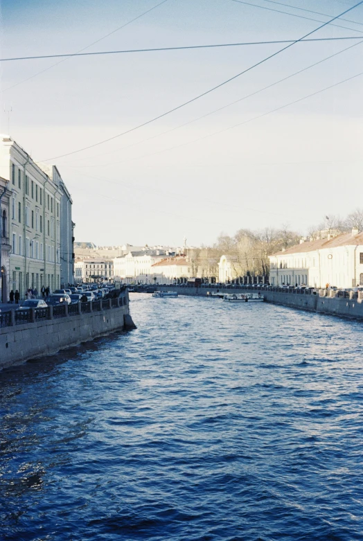 looking down an canal from a bridge near buildings