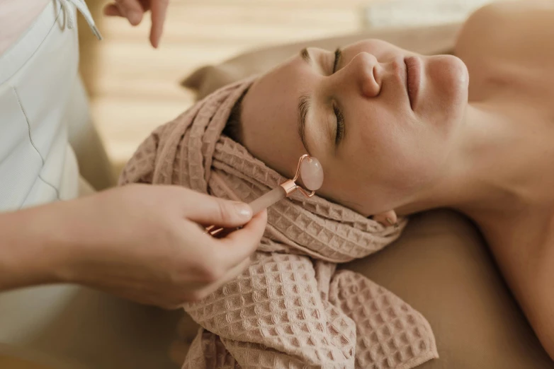 a woman getting her eye examined by an electric device