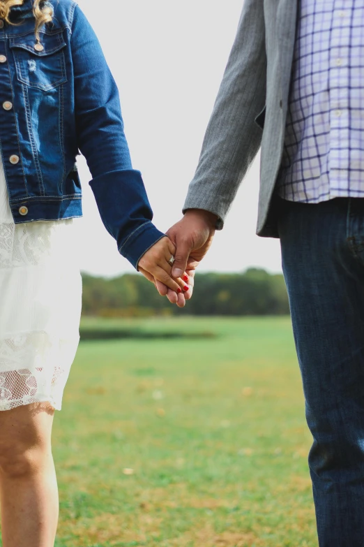 a close up of a person holding hands with another persons hand