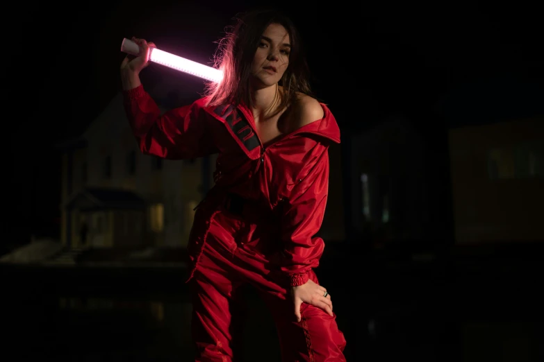 a woman with a red and black light saber on her shoulder