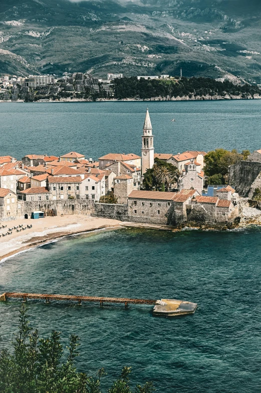 a boat is sitting in the water next to a village