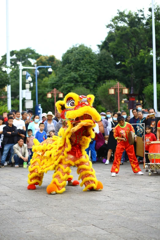 a woman is dressed in yellow and dancing with another man