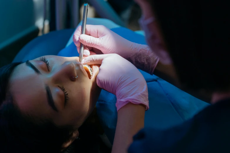 a woman who is getting her eyebrows checked by an expert