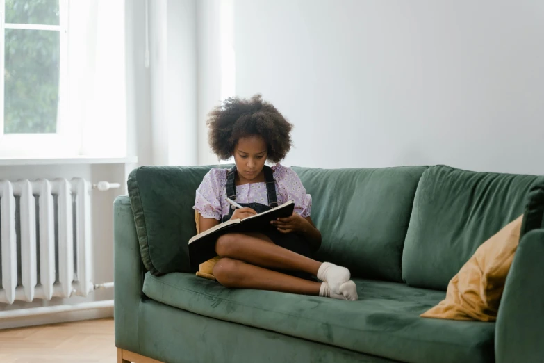 a person sitting on a couch with a book