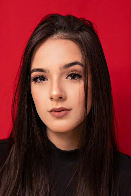 young asian woman in front of red background