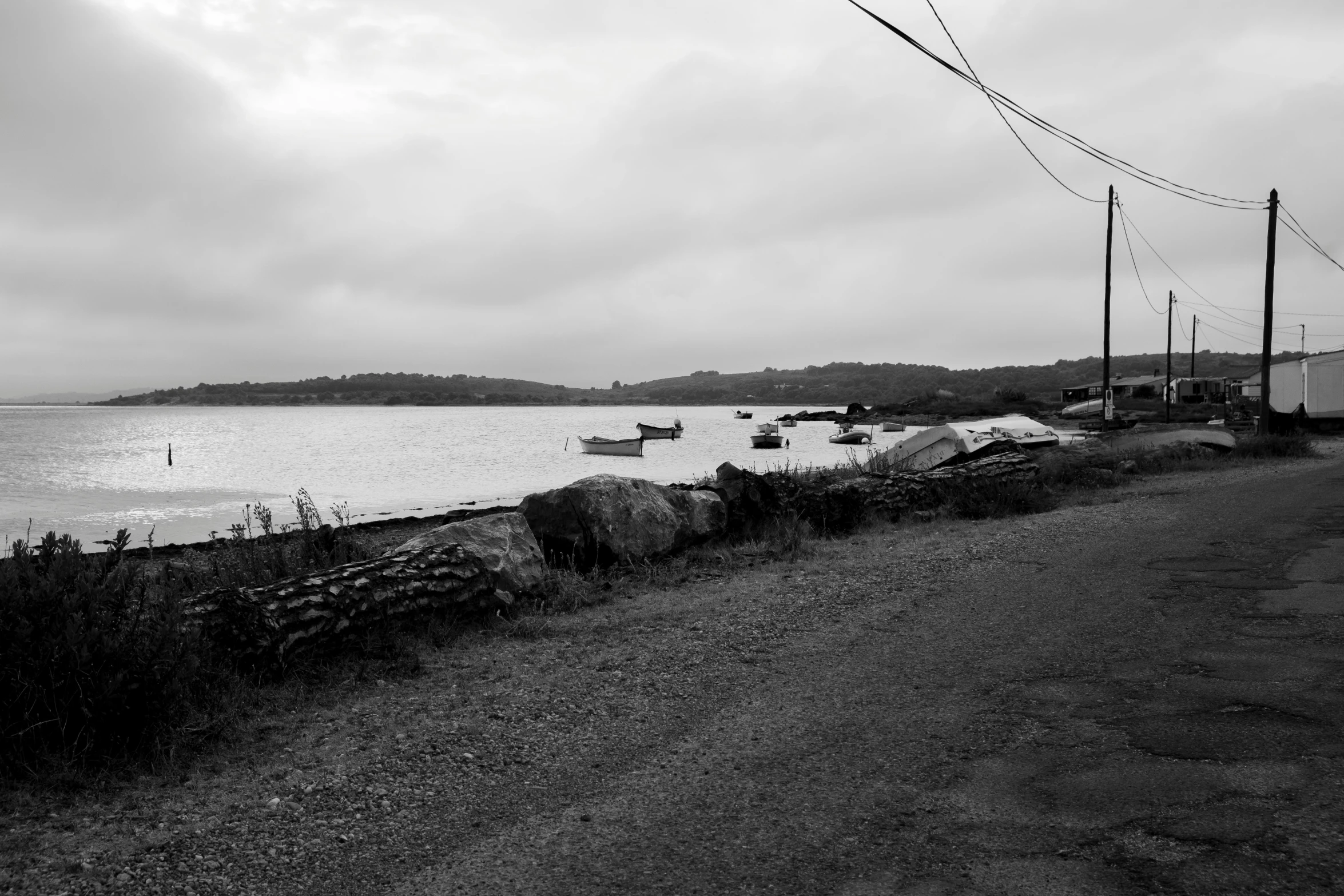 many boats are anchored in the water in the dark