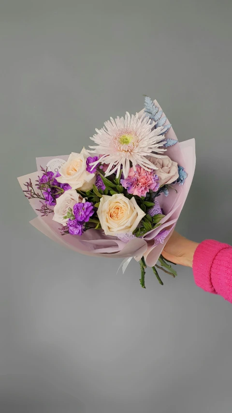 the flowers are being held in a female's hands