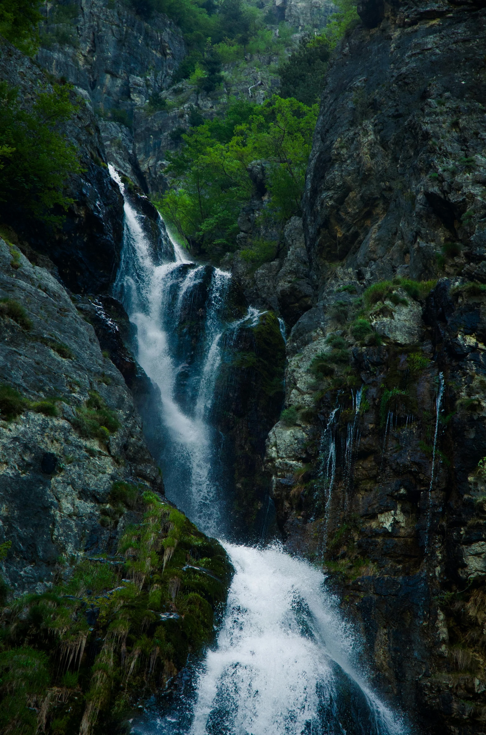 a man walking in front of a waterfall