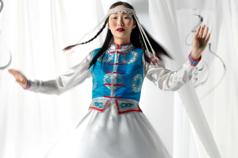 a  wearing an oriental outfit dancing