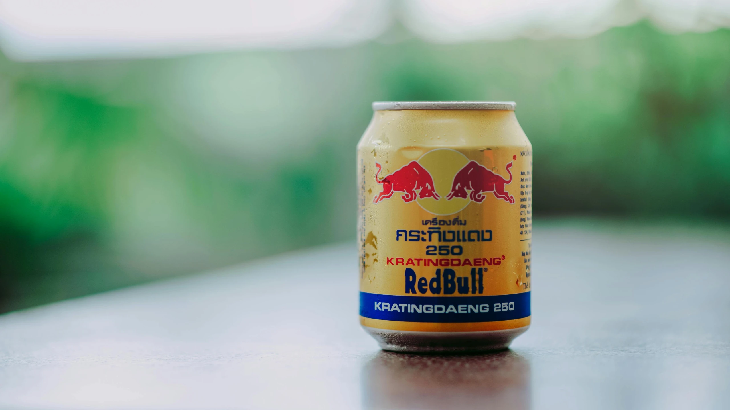 a can of beer sitting on top of a table