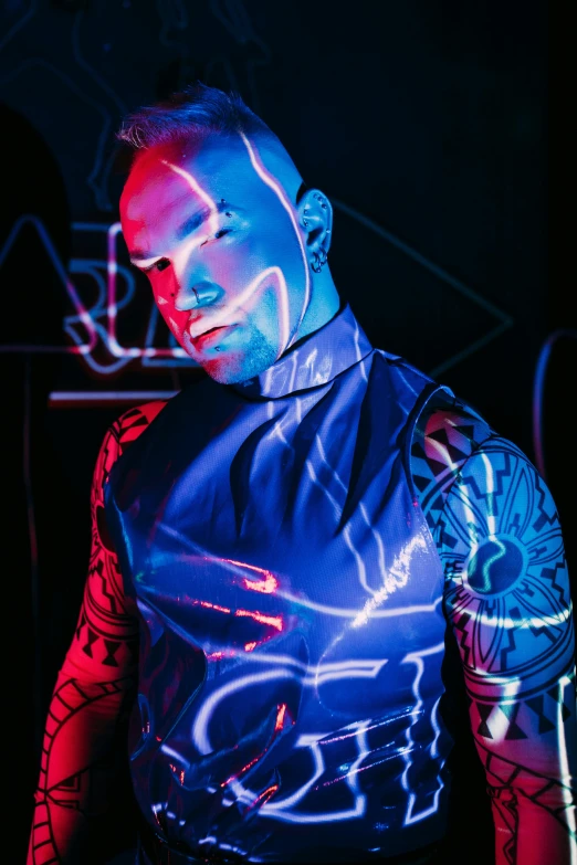 the man wearing a leather vest has his light painted on his face