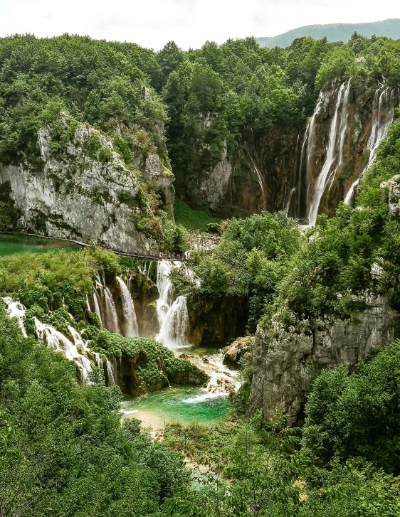 a waterfall on a hill near a river