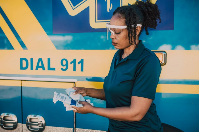 a woman holding soing in front of a van