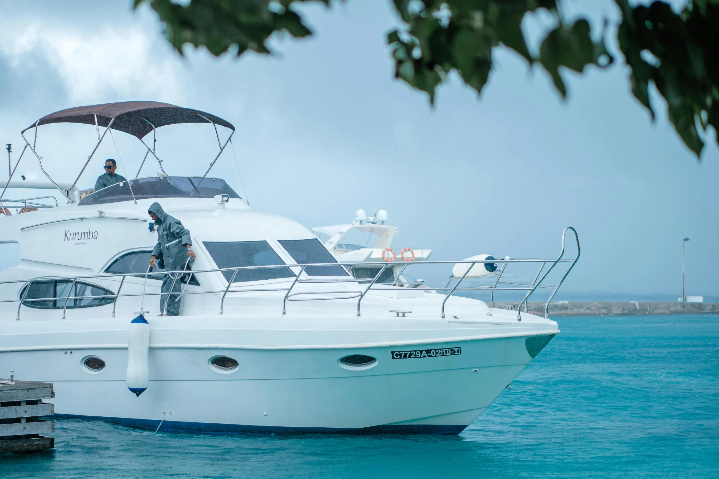 people sitting in the back of a boat on blue water