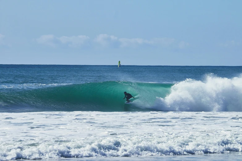 a man riding a wave on top of a surfboard