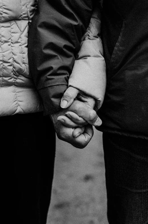 two people holding hands with their fingers