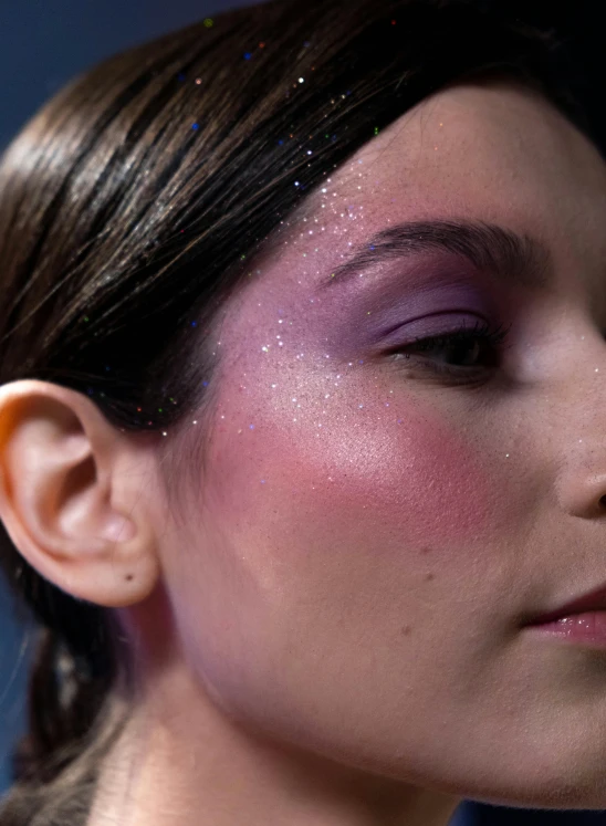 a woman with bright pink and silver glitter makeup